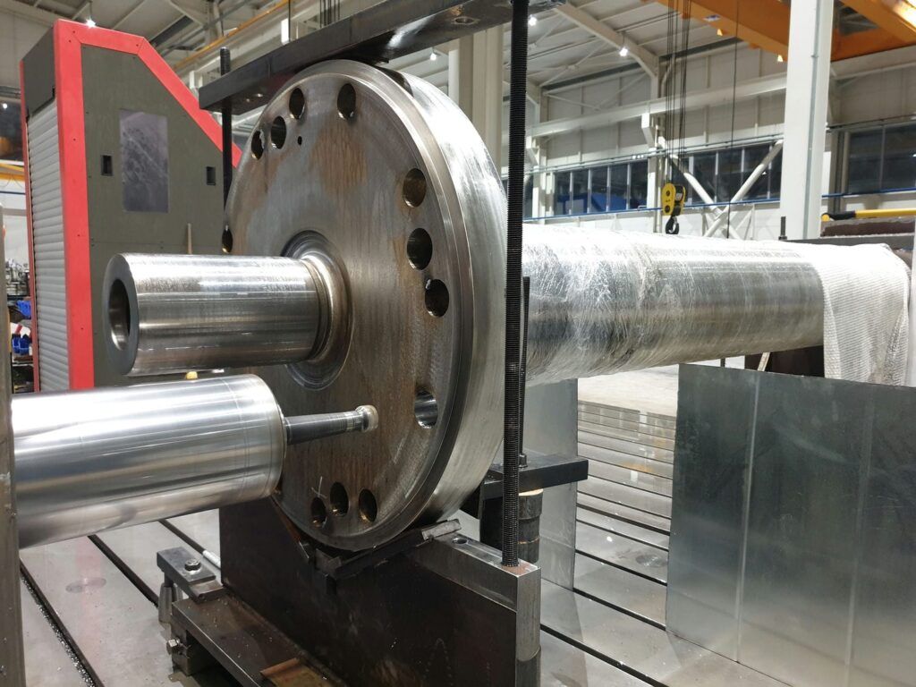 The flange was machined on our CNC boring machine where all flange holes, diameter, faces and the shaft central bore, were restored to original condition-form